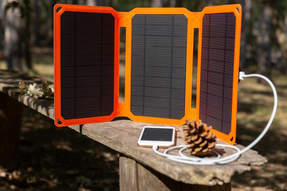 Smartphone,Is,Charging,From,Solar,Battery,In,Summer,Camping.,Clean